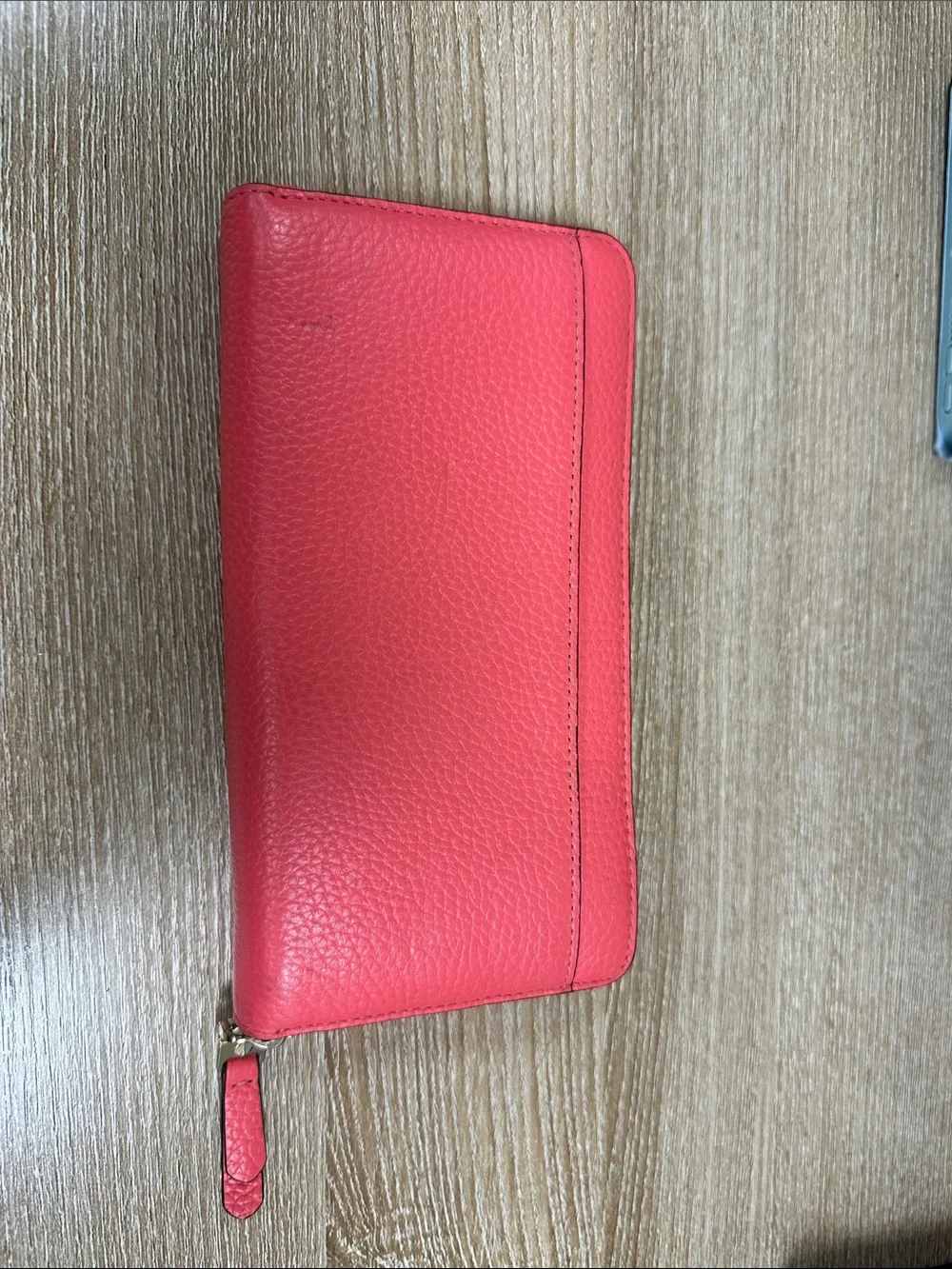 kate spade coral pink zip-around pebble leather wallet with wrist strap